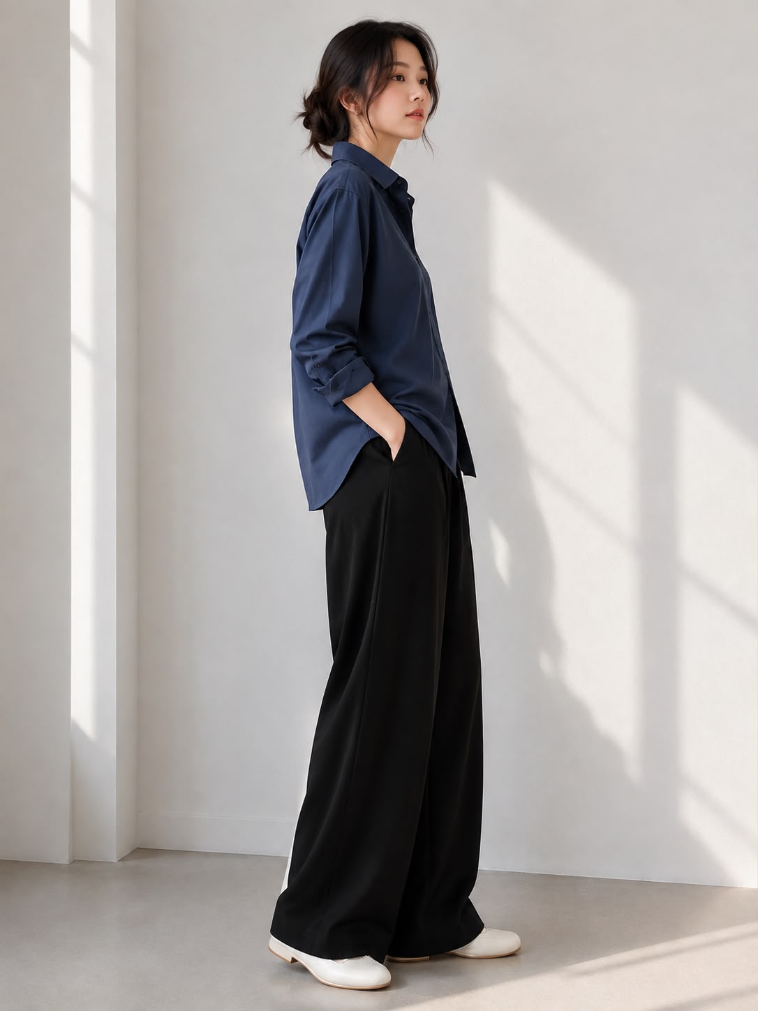 Midnight Navy — side view of the Everyday Oversized Shirt worn with black wide-leg trousers