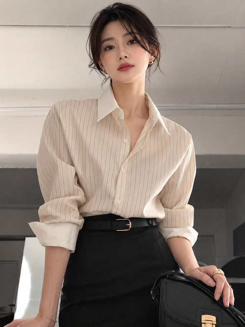 Ivory Pinstripe — model in the Striped Oversized Shirt with sleeves rolled, worn with a black belt and skirt