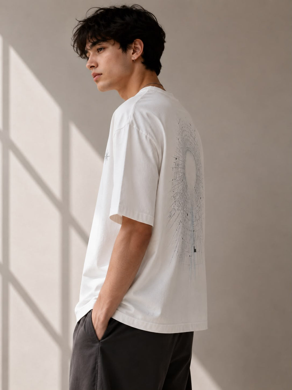 Off White — model in the Oversized Graphic T-Shirt, turned away so the print wraps the shoulder