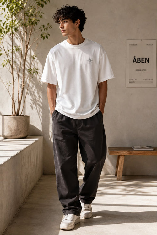 Off White — full-length view of the Oversized Graphic T-Shirt worn with charcoal trousers