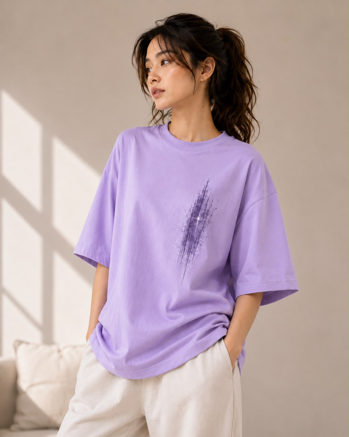 Wisteria — model wearing the Abstract Saint oversized tee with cream trousers, front view